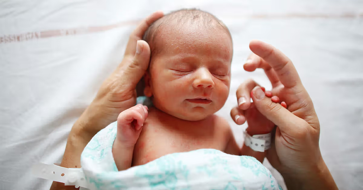Parent caring for a newborn during circumcision healing