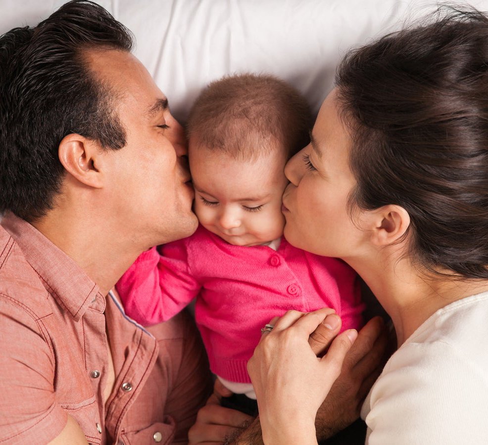 Parent holding baby after circumcision care